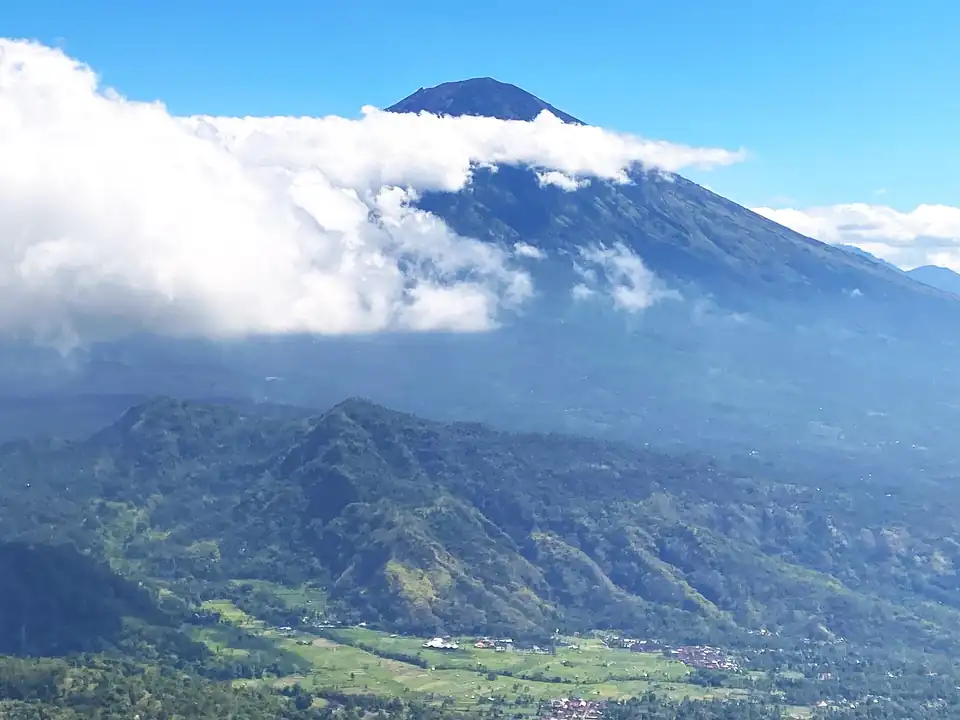Mount Agung rising above the clouds, the view from the hills above Amed