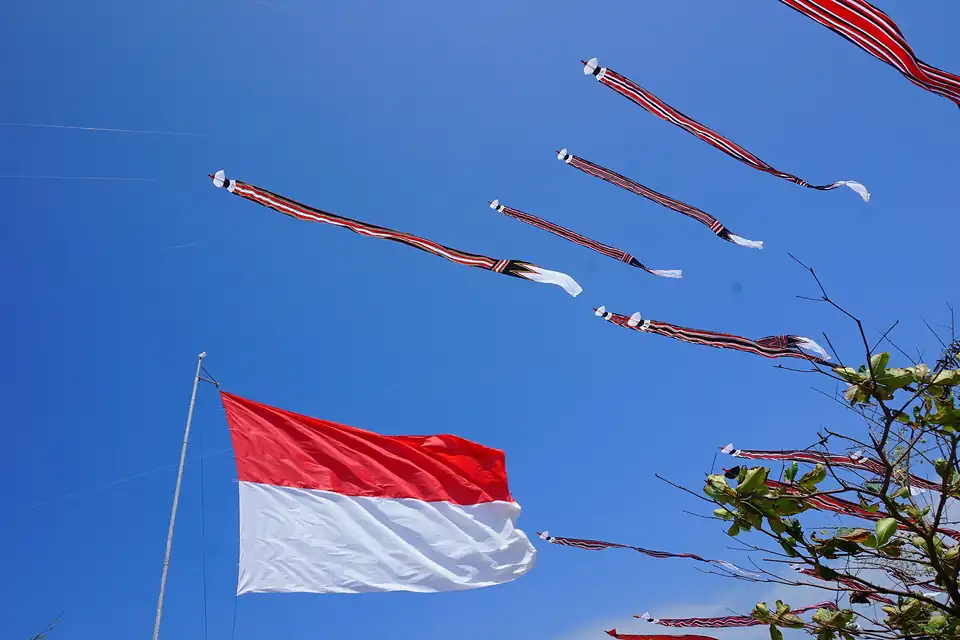 A giant traditional kite and the national flag at Mertasari