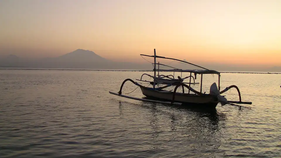 A jukung on the still water off Sanur at dawn