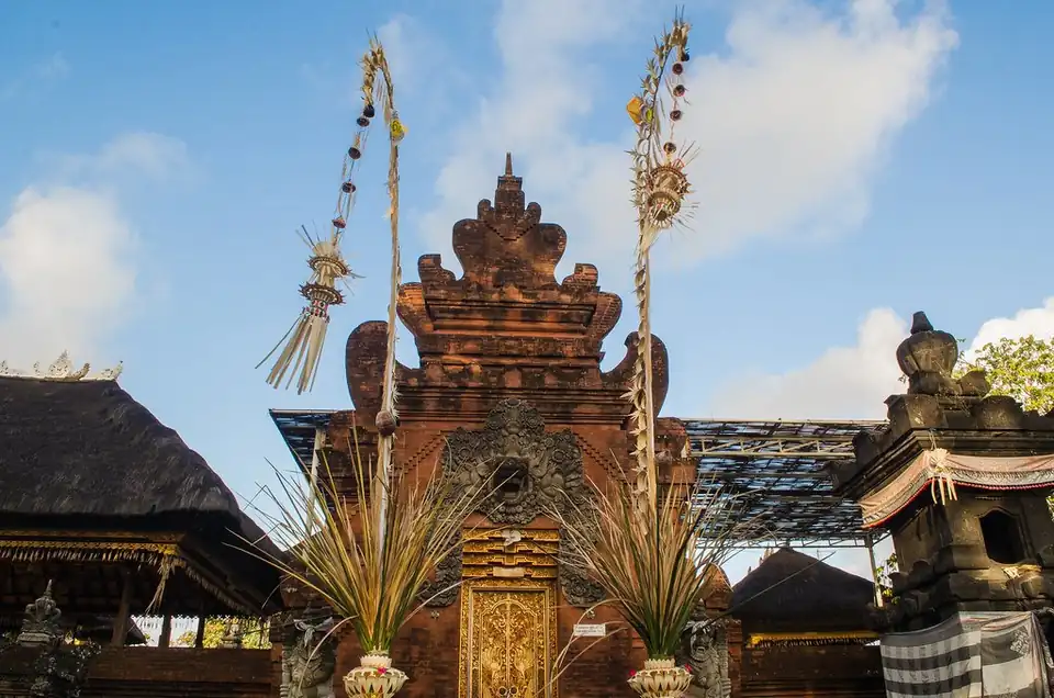 Penjor and a carved gate at Pura Petitenget