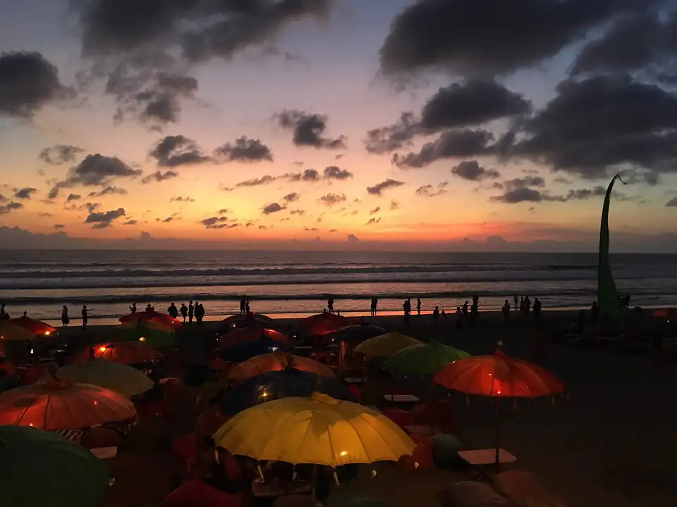 Seminyak Beach at sunset with beach-club umbrellas