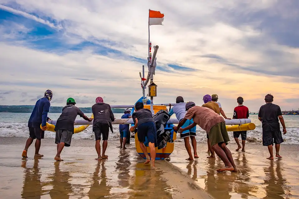 Fishermen pushing a boat out at Kedonganan