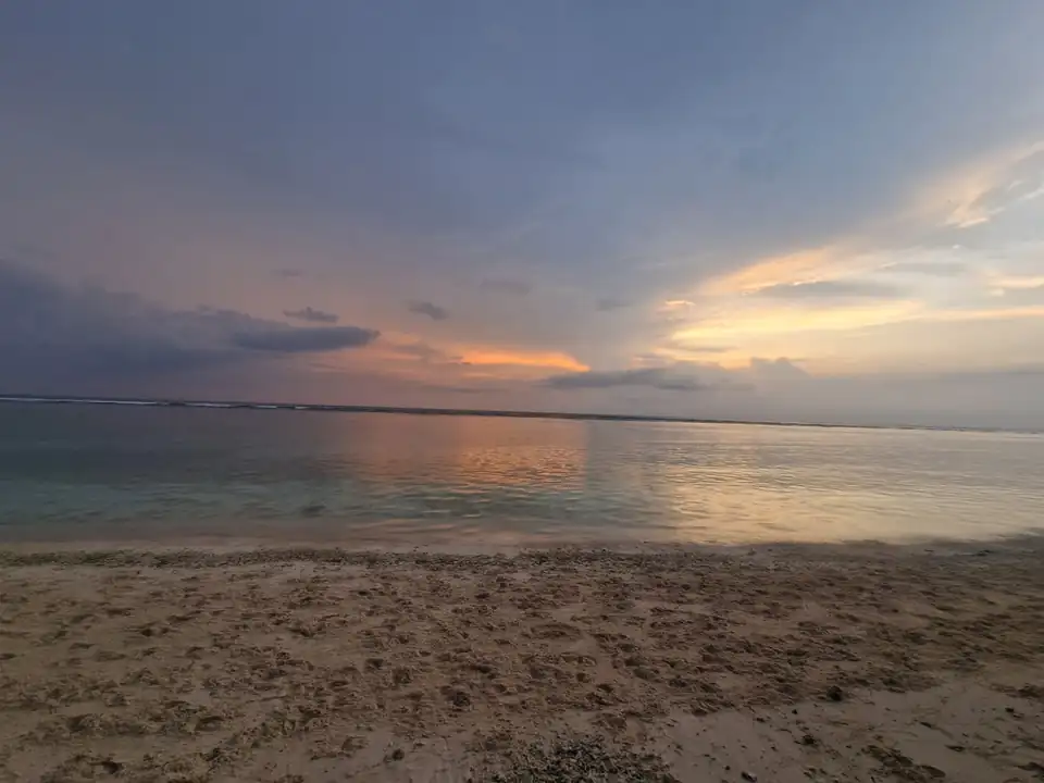 The last of the light on the sand and the shallow reef at low tide