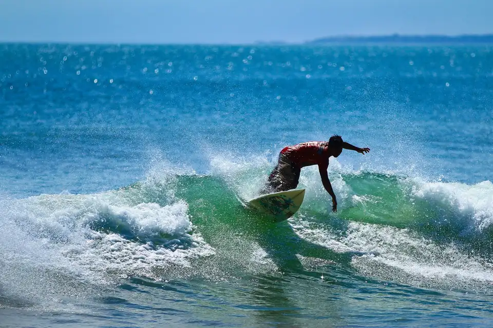 An Indonesian surfer riding a wave at Kuta