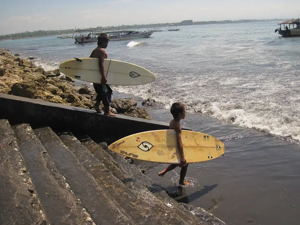 Young surfers on the beach at Sanur