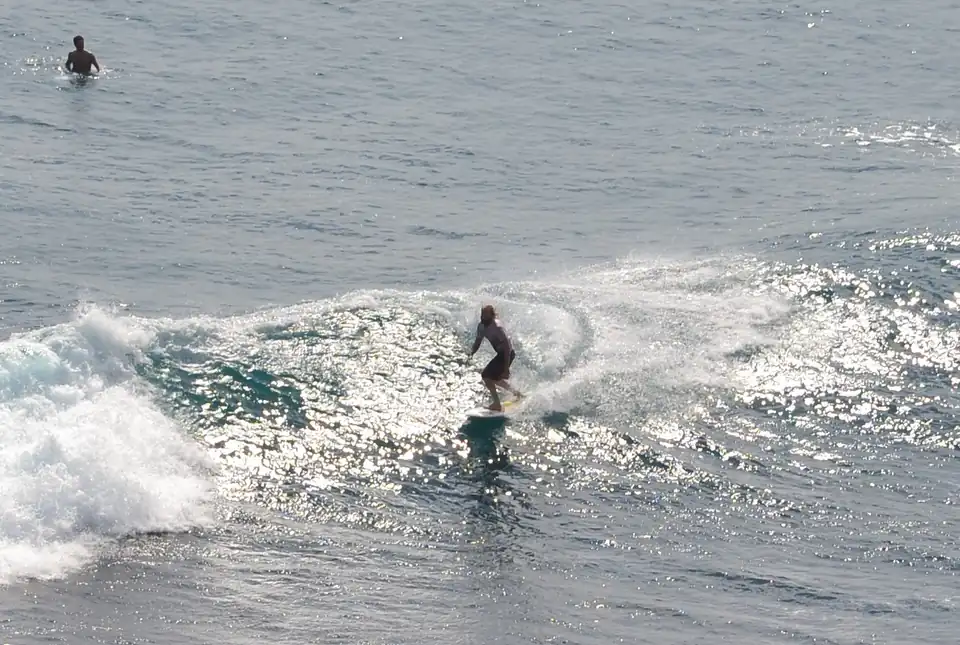 A surfer on a wave at Uluwatu