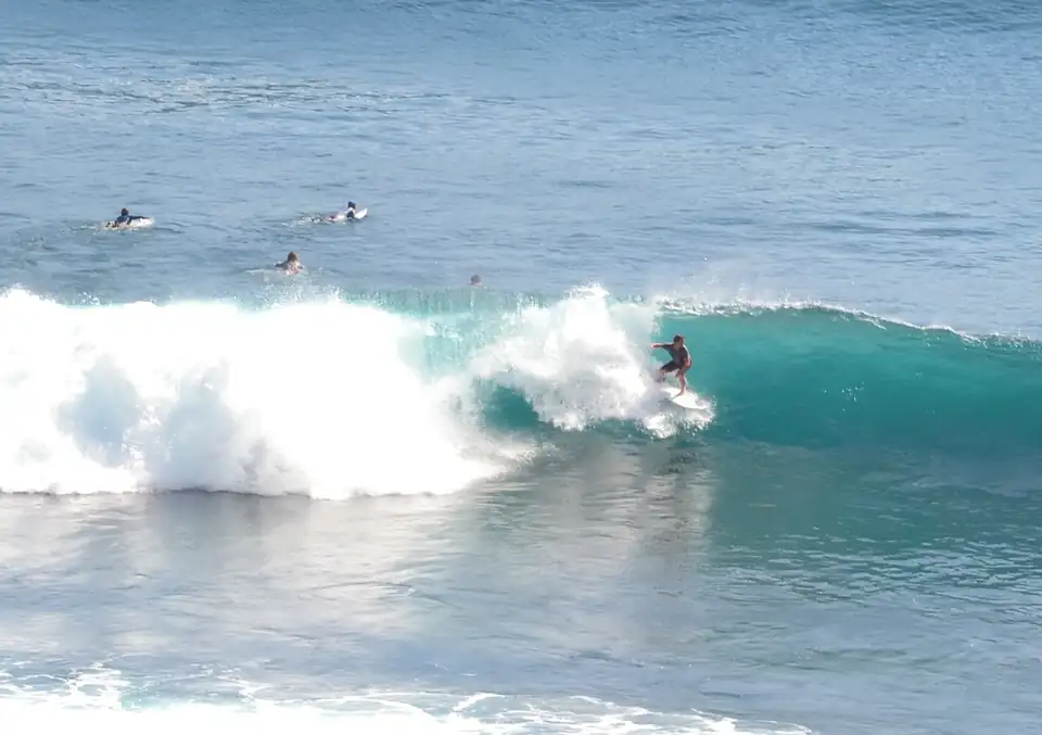 Surfers on the reef at Uluwatu