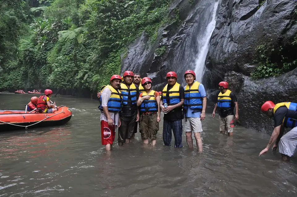 Rafters stopped below a waterfall on the Ayung river