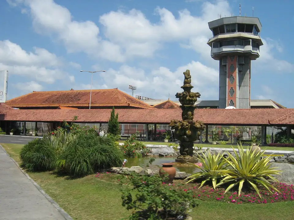 The control tower at Ngurah Rai airport behind Balinese-style roofs
