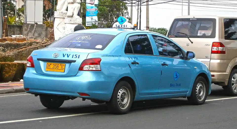 A Blue Bird taxi on the road in Kuta, Bali