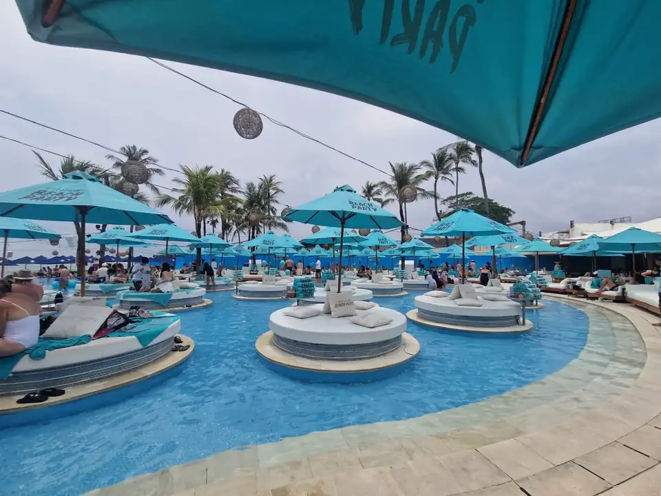 Round daybeds set in the shallow water of a Canggu beach club pool