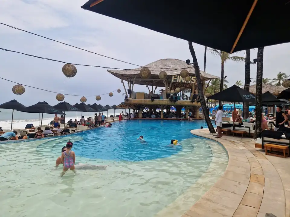 The main pool and thatched bar at Finns Beach Club on the sand at Canggu