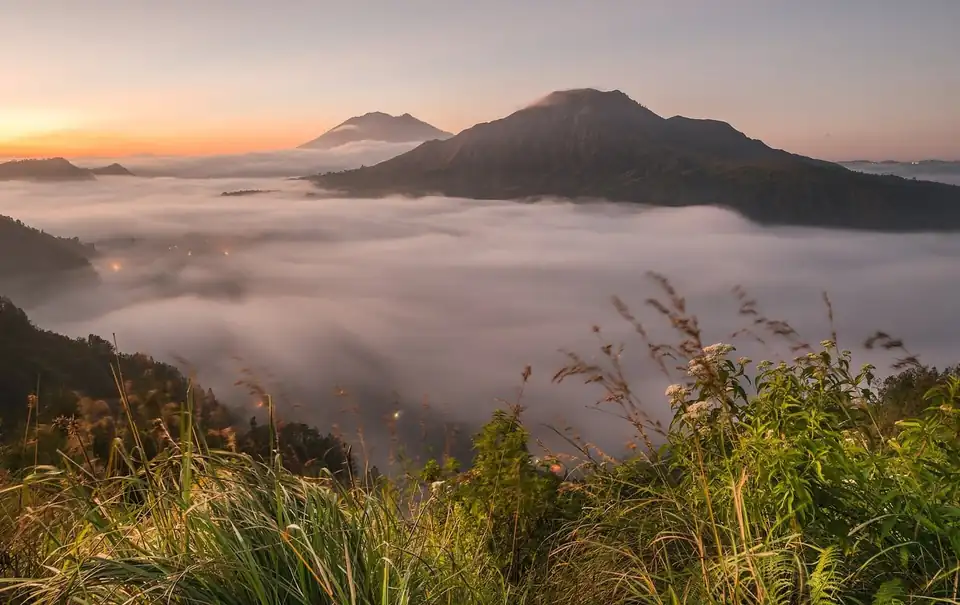 Sunrise over a sea of cloud filling the caldera at Kintamani