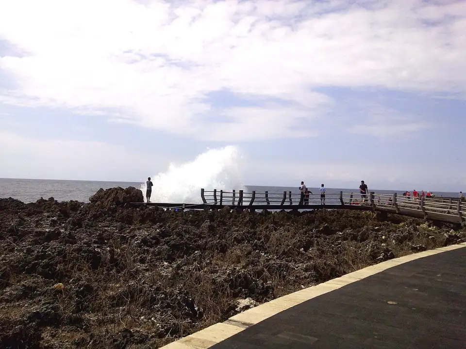 A wave bursting up over the rocks at Waterblow, Nusa Dua