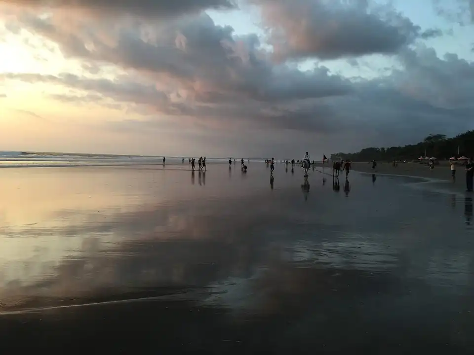 Reflections on the flat sand as the tide drops at Seminyak