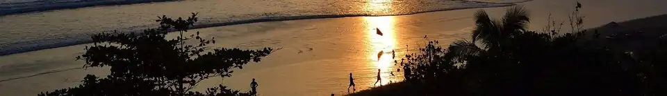 Low sun over the water and wet sand on Seminyak beach