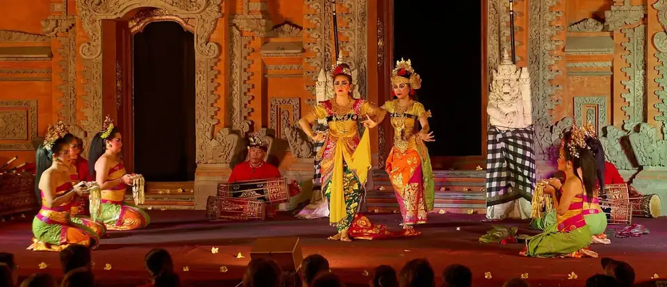Legong dancers performing the Ramayana on a lit temple stage in Ubud