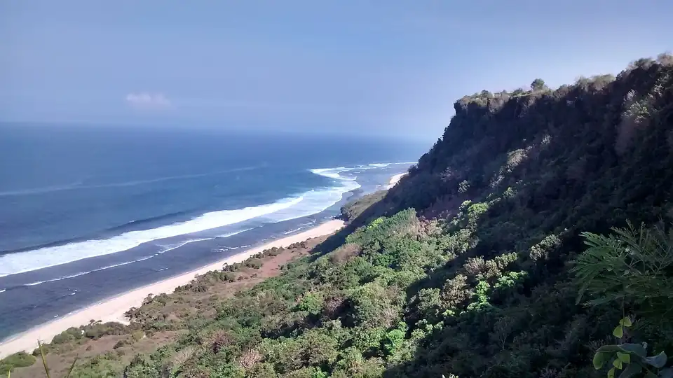 Limestone cliffs dropping into the sea at Pecatu